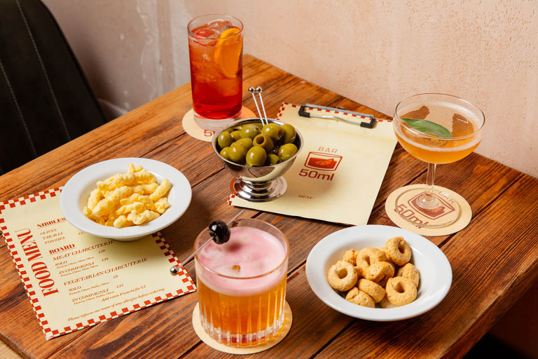 nibbles and cocktails served on the wooden table at bar 50ml