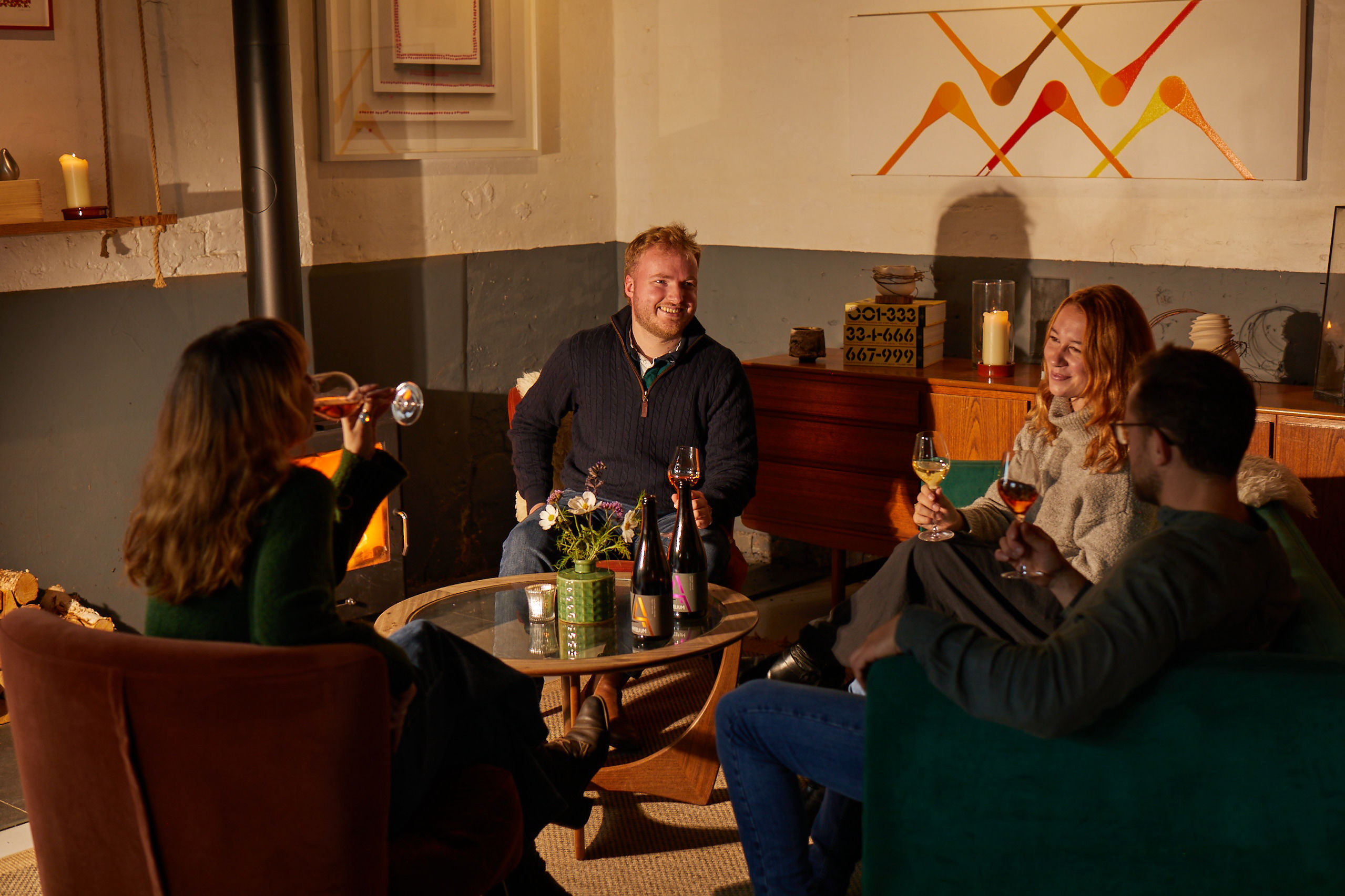 a group of people sat down enjoying a glass of wine