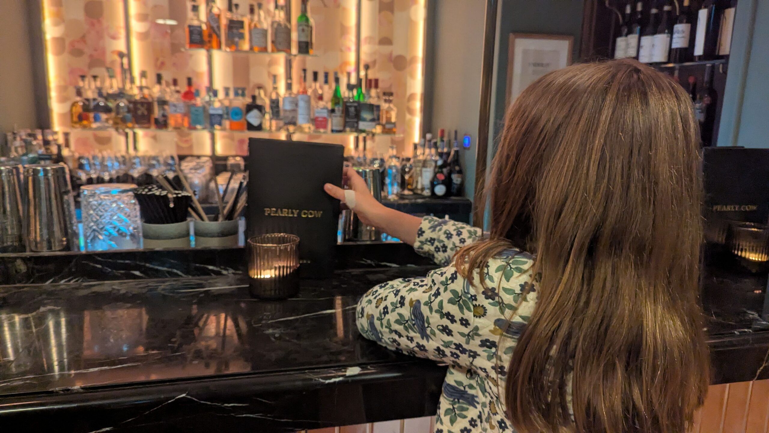 a girl holding Pearly Cow menu