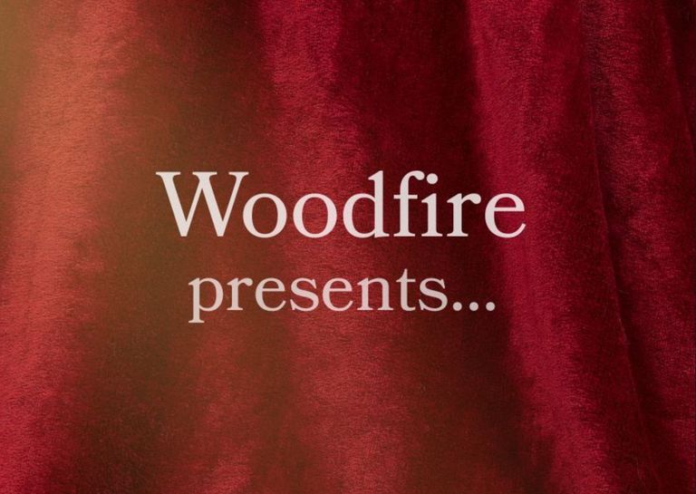 A red velvet drap background with white text that reads Woodfire presents...