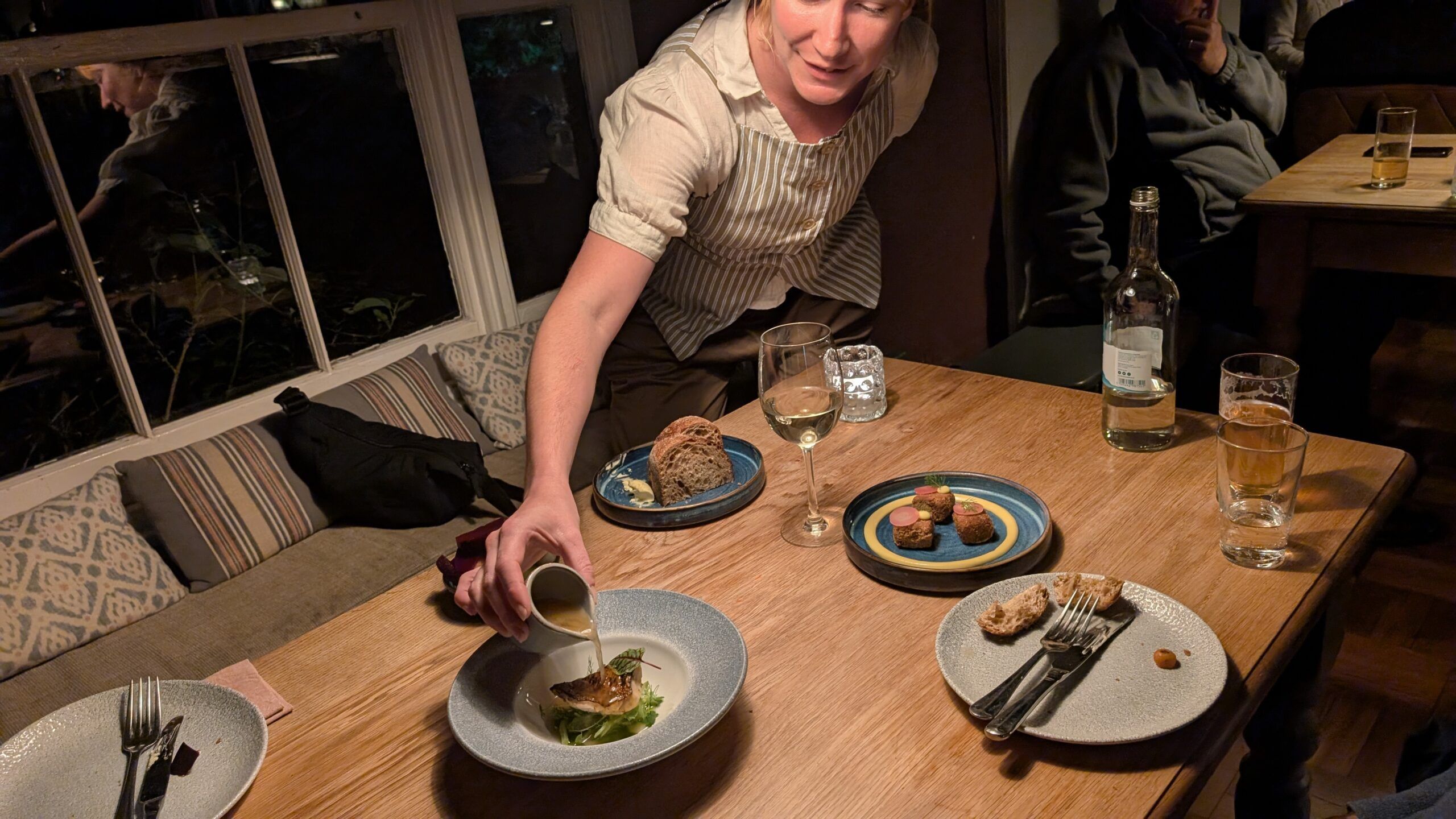 waiter serving food on the table