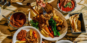 Festive menu at DIshoom Permit Room Overhead photo of a festive feast with lots of food and people tucking in.