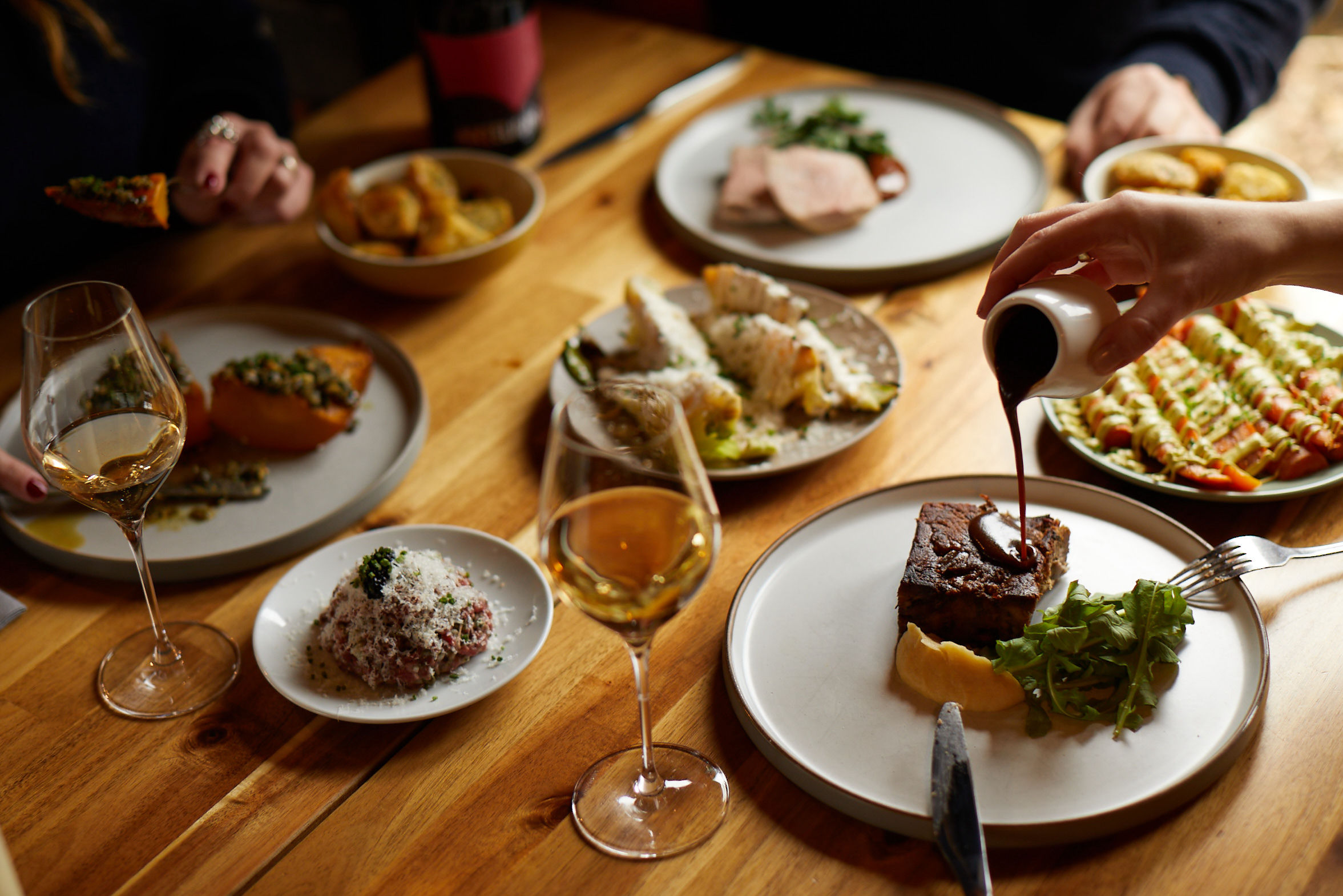 sauce being poured at lunch at Artelium