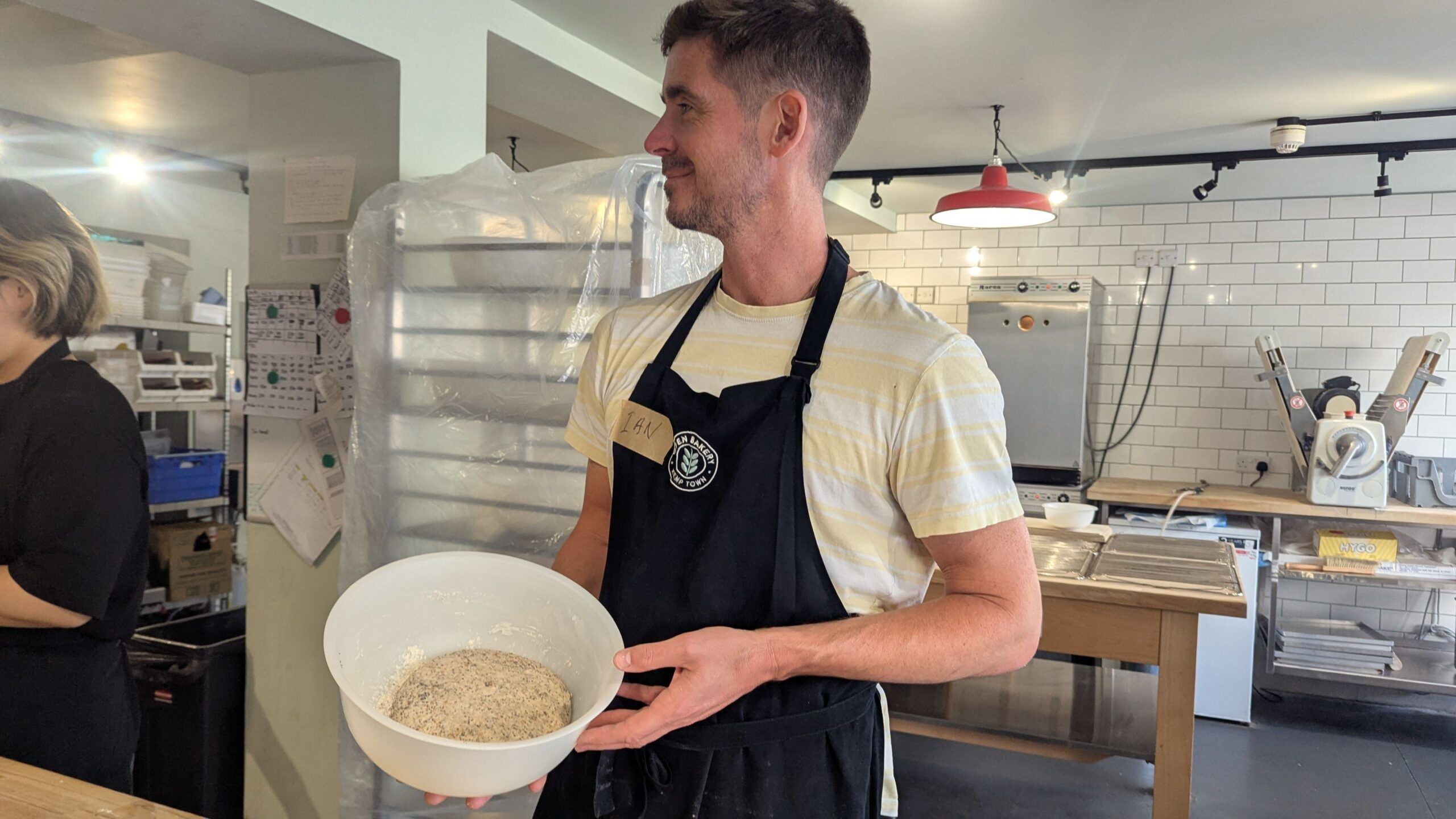 Ian holding bowl with dough for bread