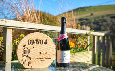 BRAVO trophy with a bottle of Ridgeview wine in the garden of Terra Restaurant at Tottington Manor in Sussex.