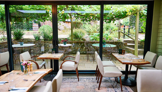 The Jolly Sportsman Pub looking out to the lush garden. Part of our food pubs guide for Brighton, Hove and Sussex.