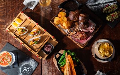 over head shot of Sunday Roast and few other dishes at Bohemia