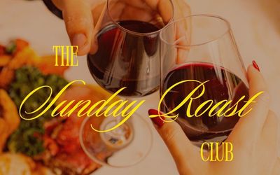 A cinematic image where there are 2 wine glasses clinking across a dinner plate that has a sunday roast on it. There is yellow script font text that says The Sunday Roast Club