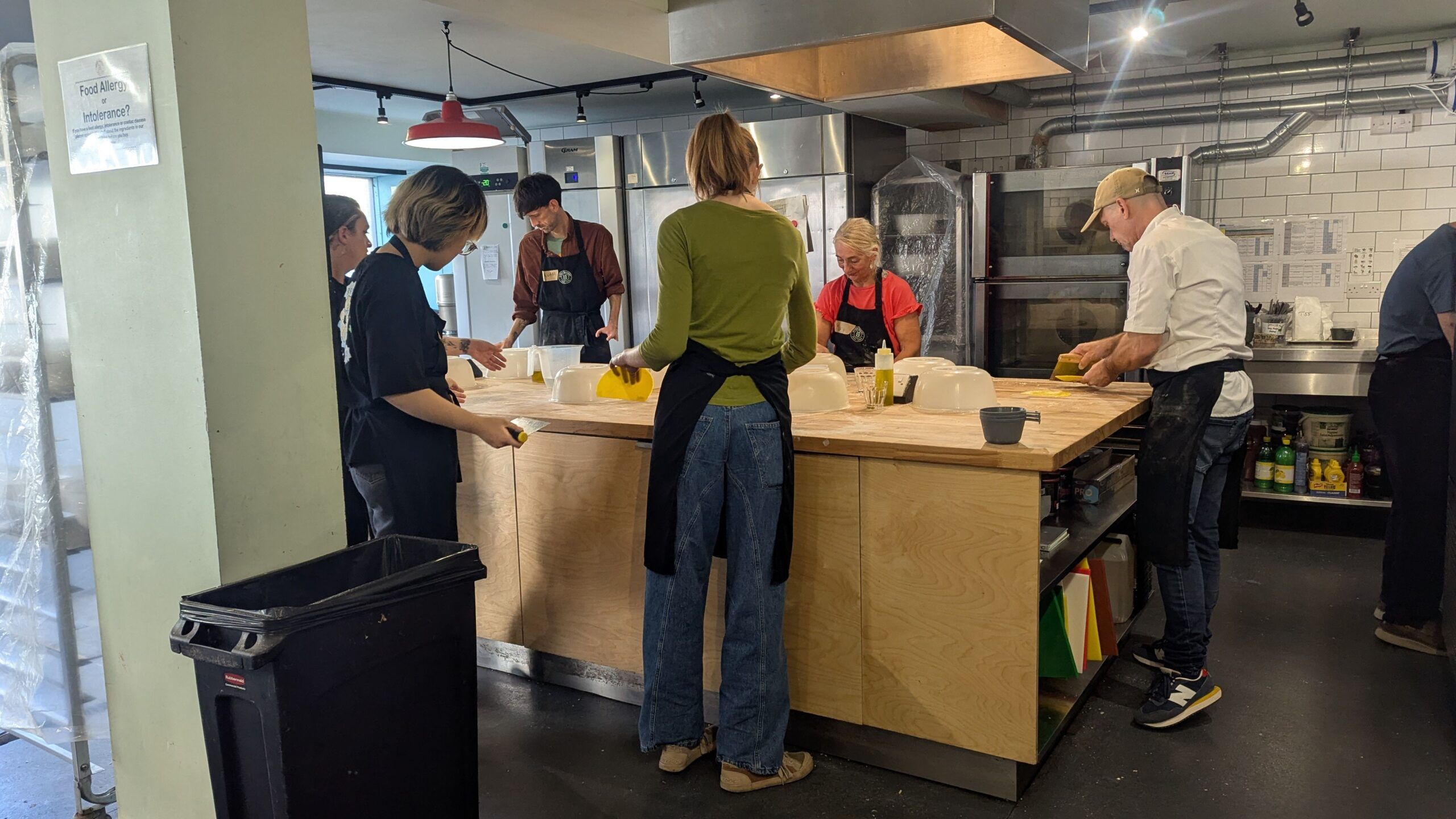 People gathered around the table of Open Bakery Kemptown cookery school