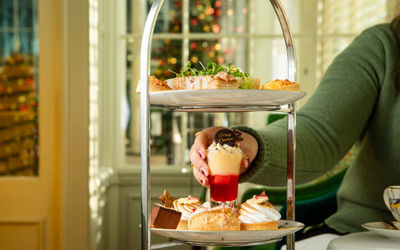 Festive afternoon tea at The Grand in Brighton with twinkly lights in the background and a Christmas tree.