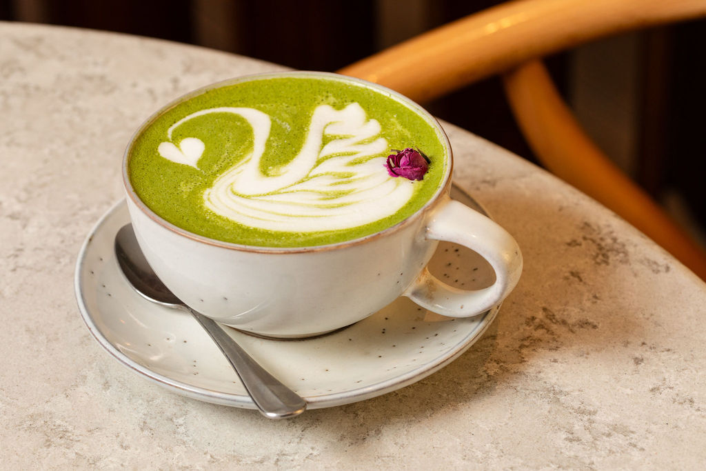 Matcha drink at Lost in The Lanes with latte art in the shape of a swan.