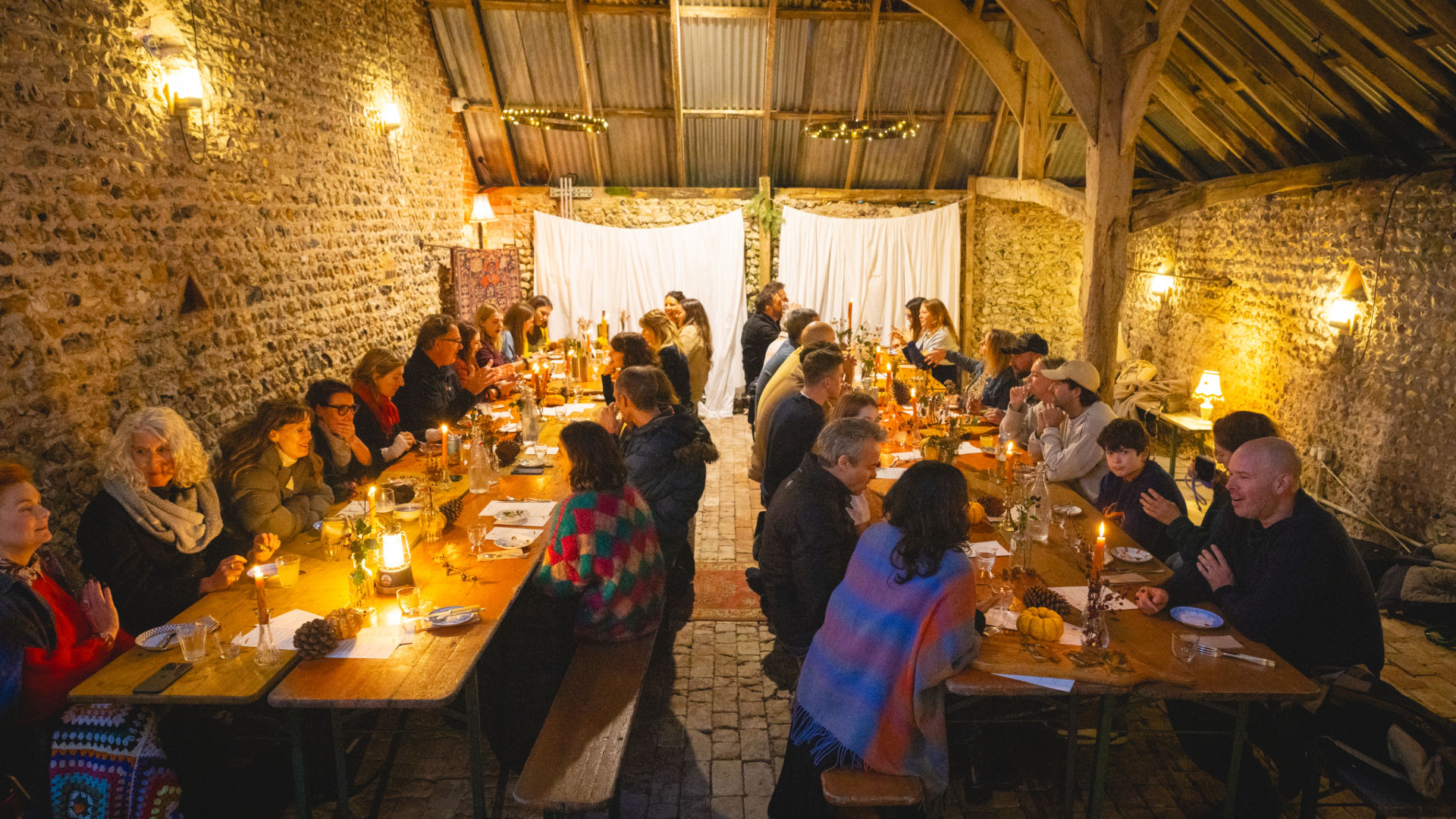 feast at one of the Woodfire Camping feast events, people sitting by the table