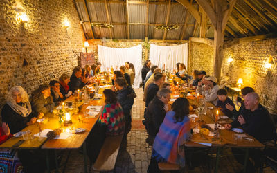 feast at one of the Woodfire Camping feast events, people sitting by the table