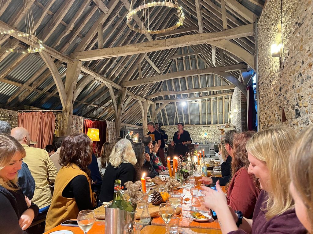 people sitting in the barn during woodfire feast