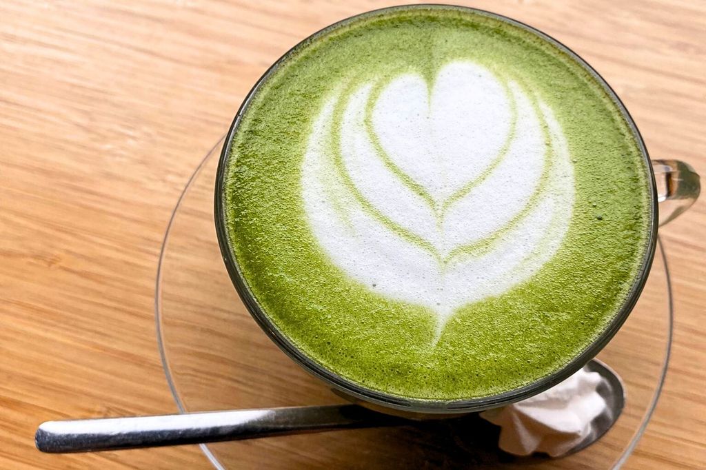 Green matcha latte drink with latte art at Brighton cafe.