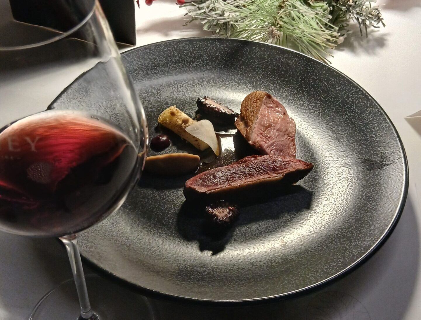 roast breasts of mallard served on grey plate and with glass of wine during a Sussex Fine Dining Experience at Terra, Tottington Manor