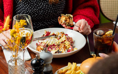 a person eating a meal with glass of wine at The North Star