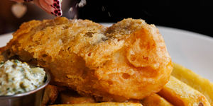 Fish and chips, mushy pes and tartare sauce, with a wedge of lemon. At The North Star Brighton