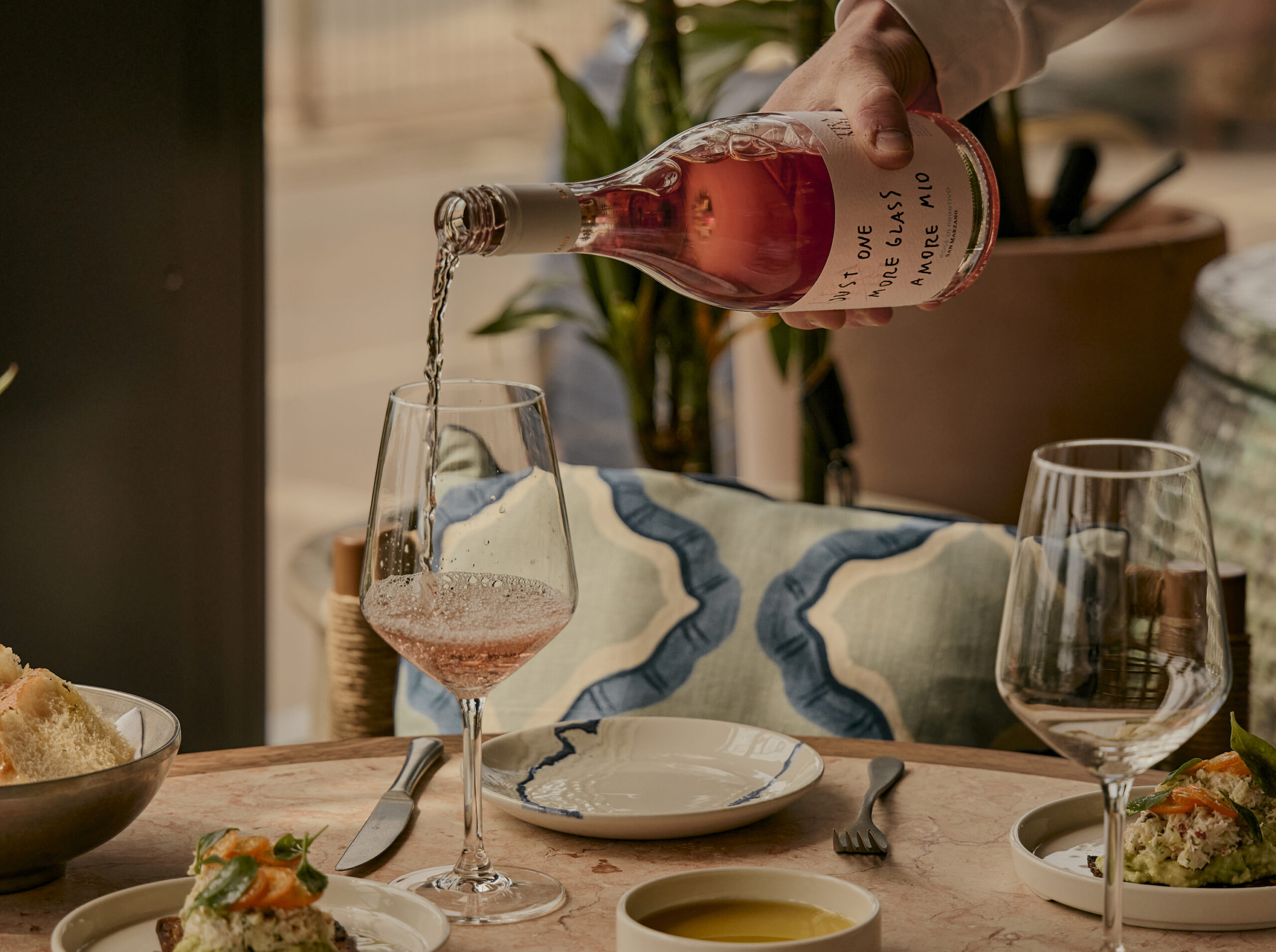 waiting staff pouring rose to the table