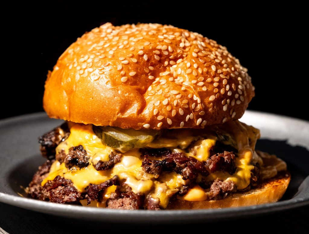 Incredible double stacked burger at Sea Lanes Brighton, Sesame bun with lots of melting cheese. Brighton Burger, Brighton seafront, by Dan Cotton.