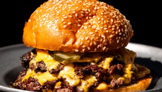 Incredible double stacked burger at Sea Lanes Brighton, Sesame bun with lots of melting cheese. Brighton Burger, Brighton seafront, by Dan Cotton.