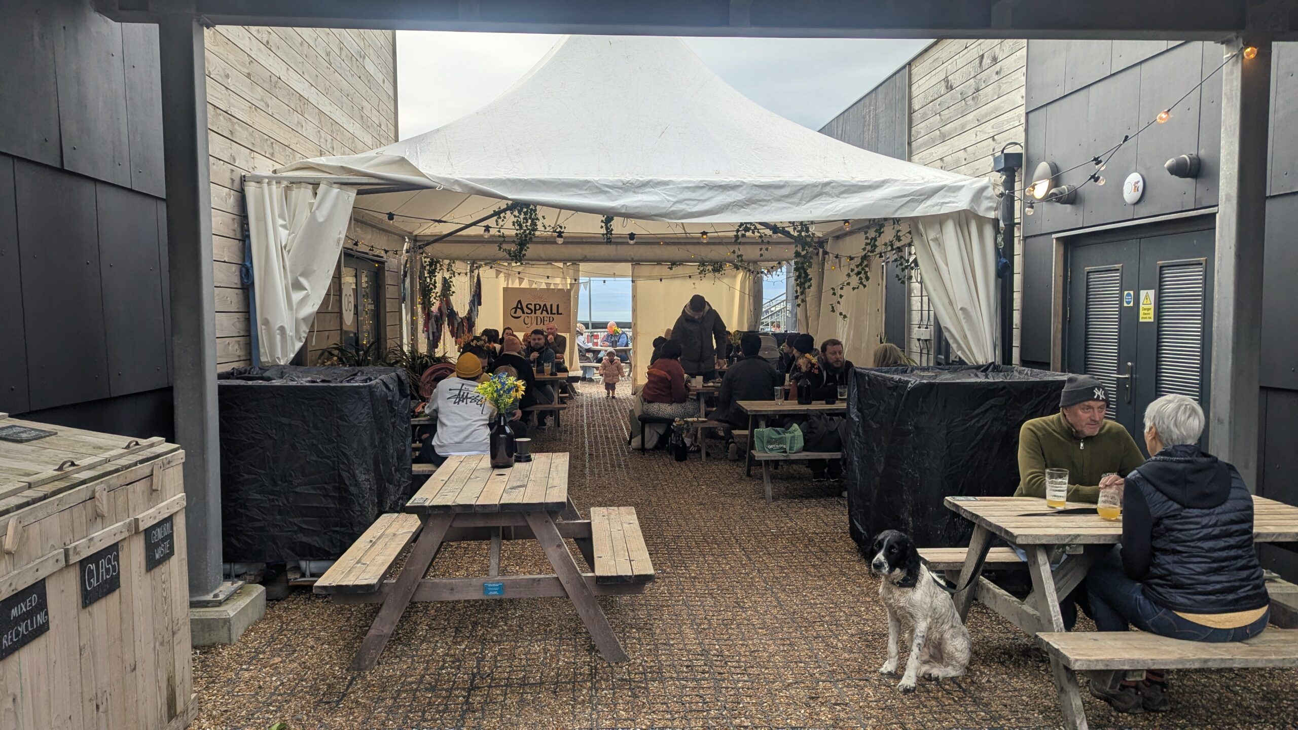 people sitting on the tables outside the sea lanes