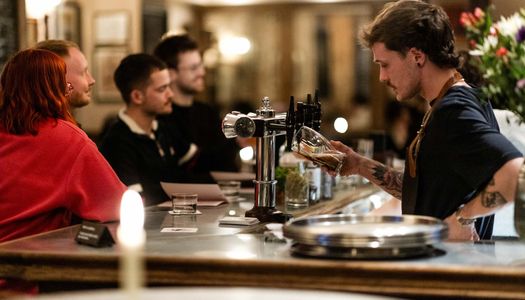 Bar person facing customers in this Brighton pub. New in 2025, The Crazy Goose