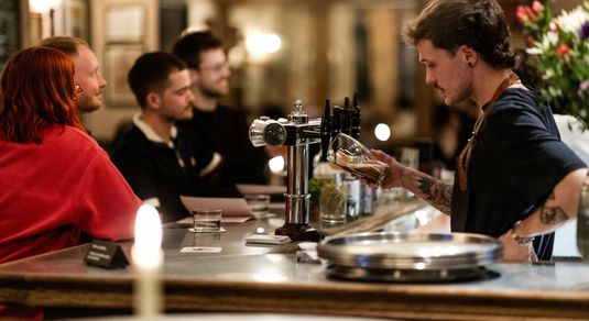 Bar person facing customers in this Brighton pub. New in 2025, The Crazy Goose