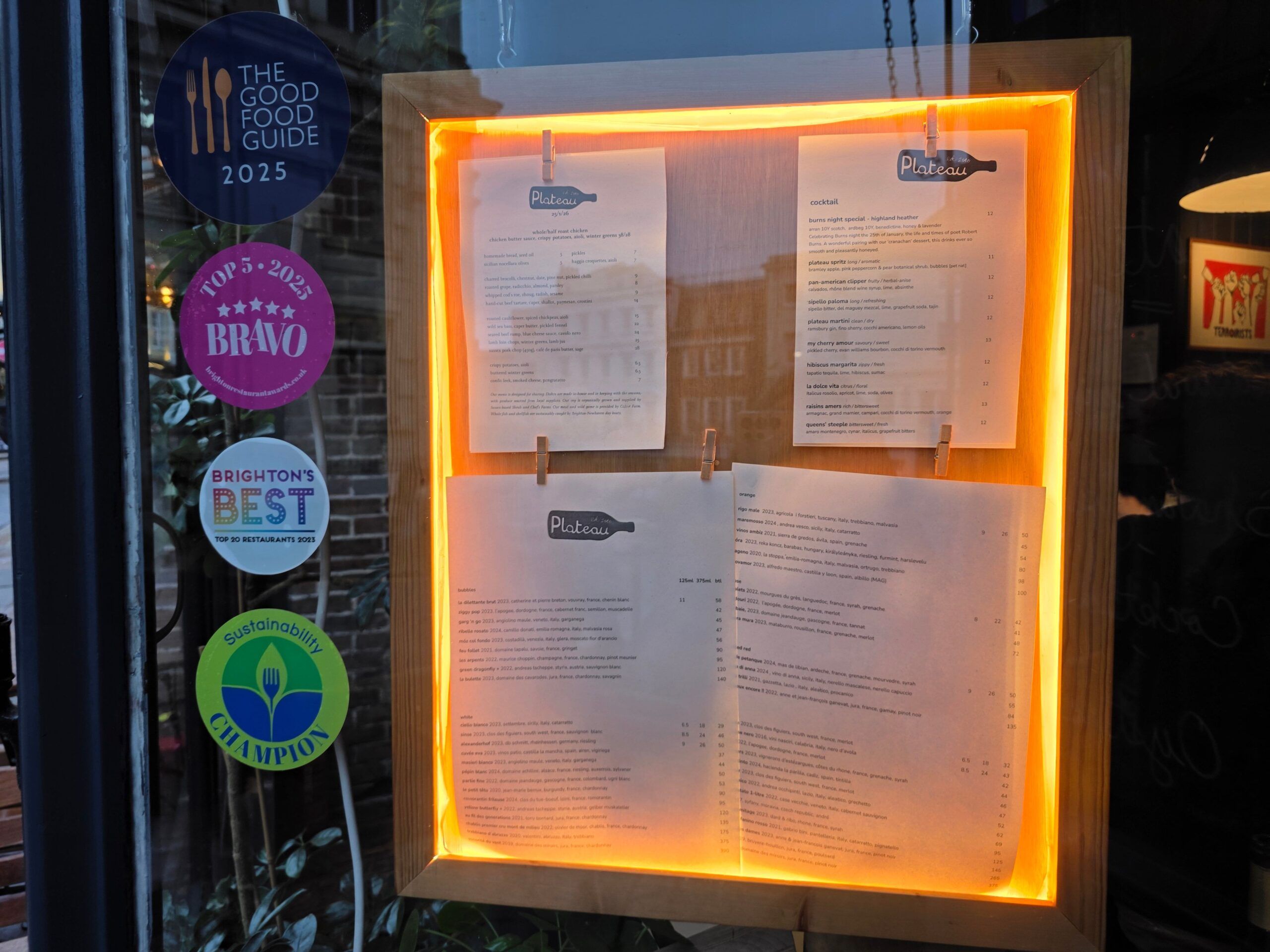 Plateau entrance door with award stickers and menu flyer