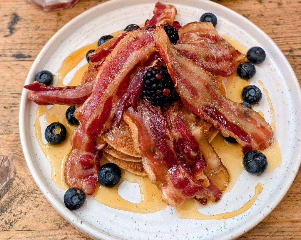 delicious pancakes with bacon, maple syrup and berries. Featured on our Kemptown restaurants page.