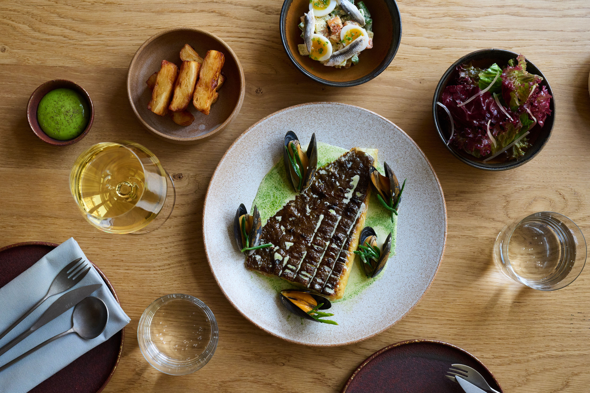 a main course selection and Maré restaurant in Brighton and Hove. Fish main course is the star of the show with mussels, chunky chips, side salad and eggs with anchovies. 