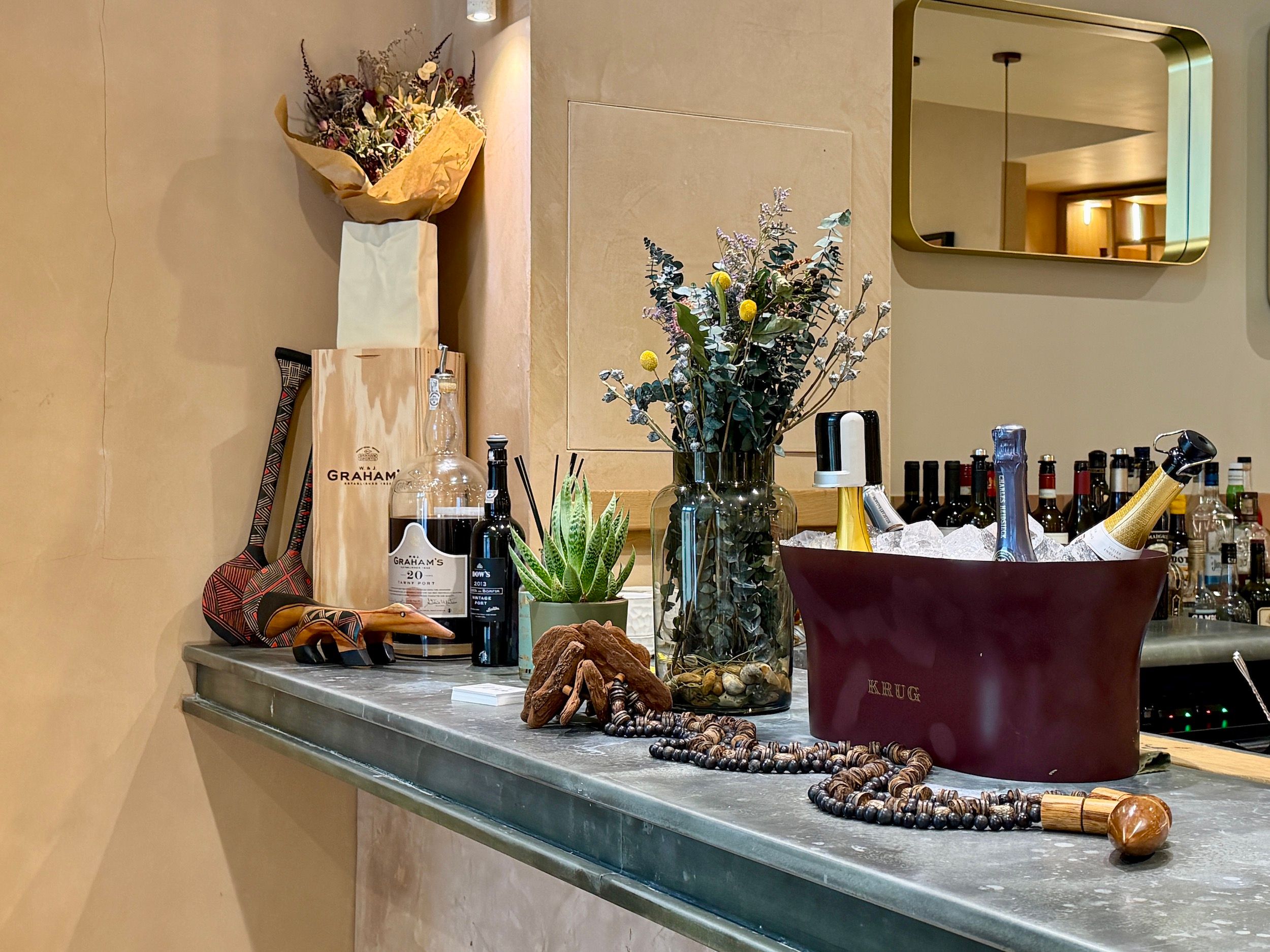 a corner bar at Maré restaurant in Hove on Church Road. An ice bath of champagne with flowers in the background. 
