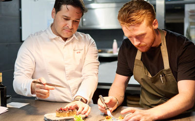 Rafael and Ewan Waller at the pass plating a dish up. Michelin star chefs in Brighton