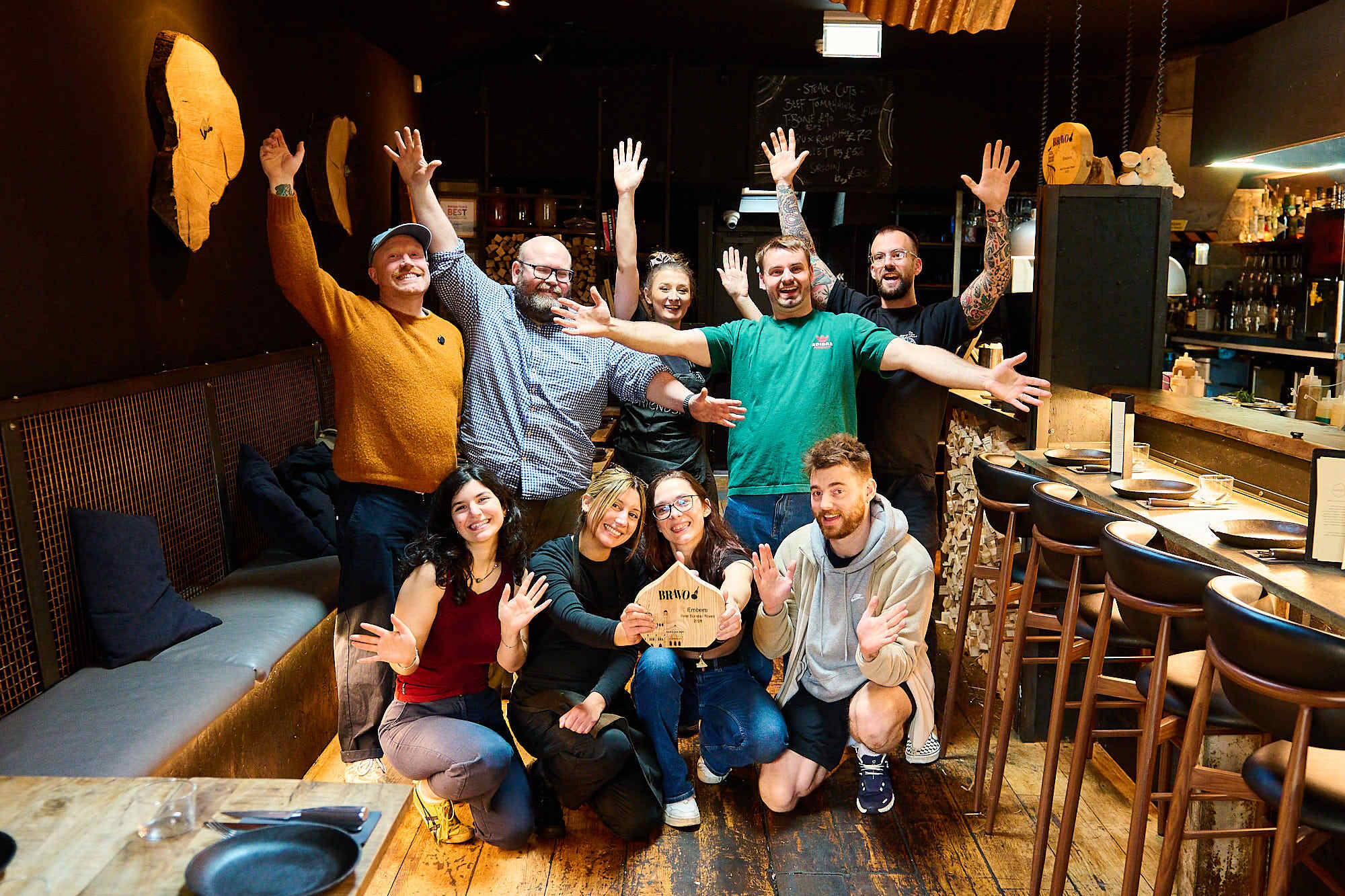 The winning team at Embers. Celebrating best Sunday Roast in Brighton and Sussex. Winners in 2025 and 2026. An interior shot of the team, all celebrating together.