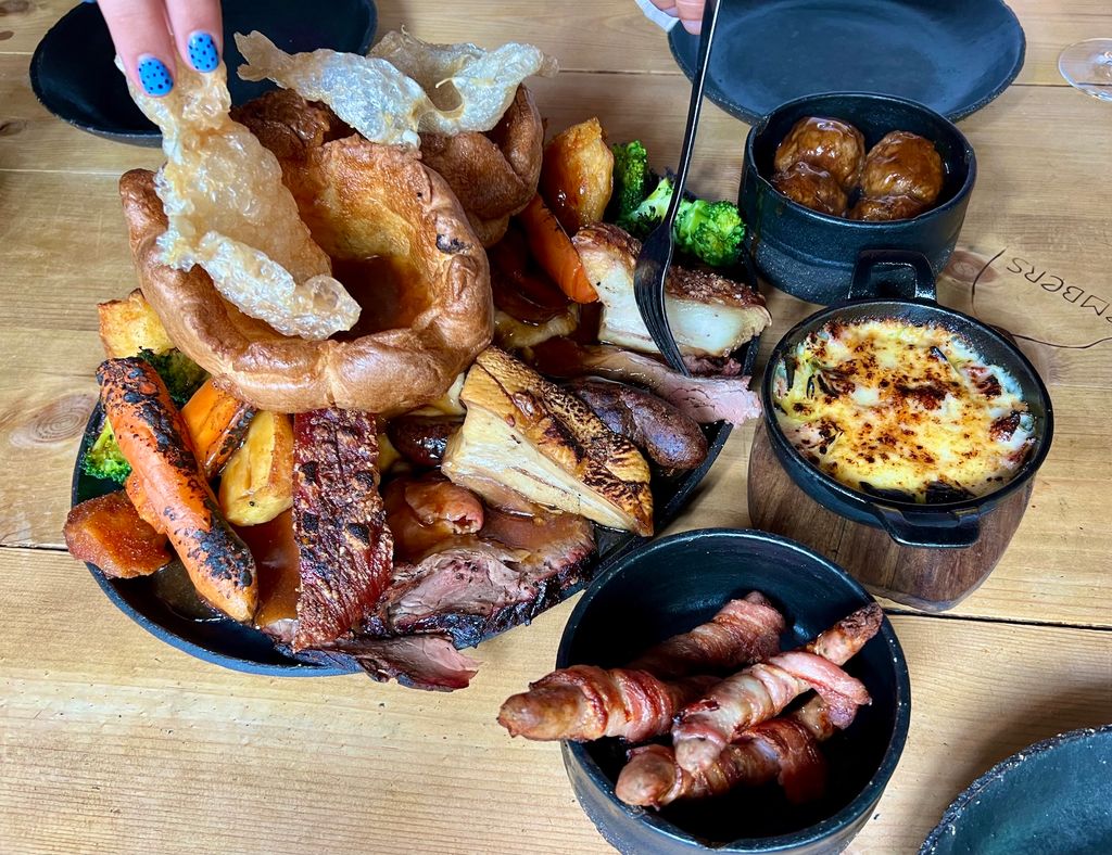 The Best Sunday Roast in Brighton. The sharing Sunday roast at Embers, in Brighton's Lanes. Winner of best Sunday roast for 2025 and 2026. Pictured pork and beef roast, Yorkshire puddings, roasted carrots, leek gratin, pigs in blankets and more.