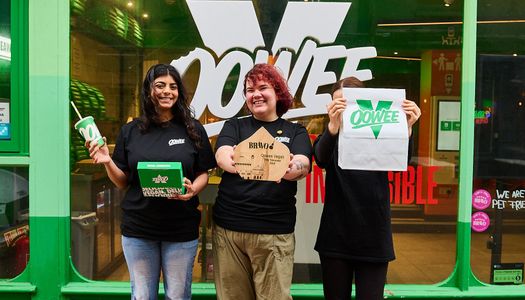 Oowee Vegan. Voted best takeaway in Brighton in 2026. Green facade of teh venue in the Lanes, with 3 staff members