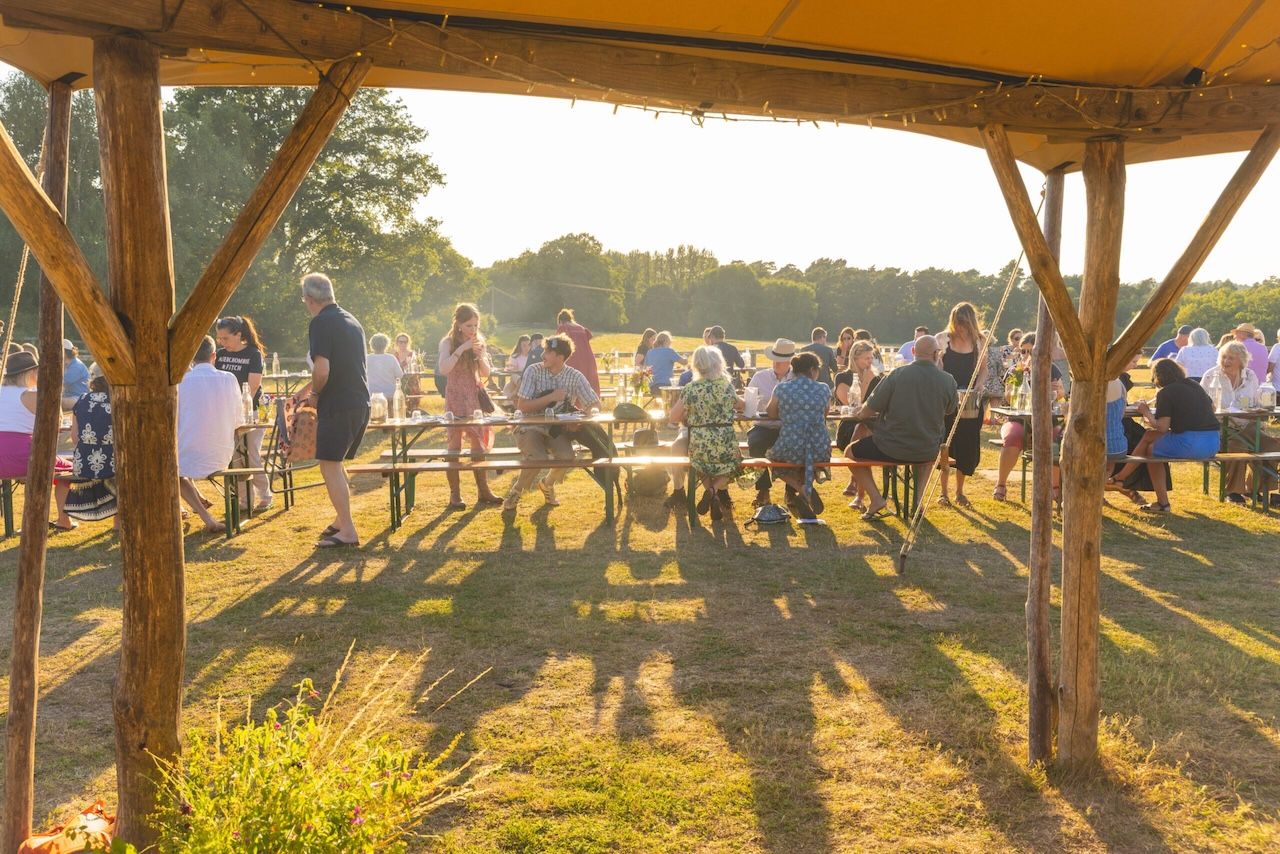Gourmet Camping at Woodfire Camping. Guests enjoying food at a gastro campsite in Sussex
