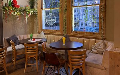the inside of La Piazza restaurant in Hove, window seat, table and chairs