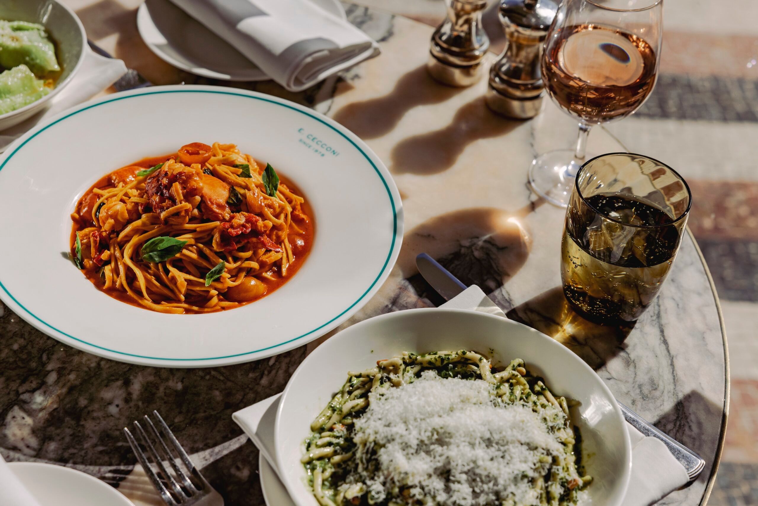 a plate of colourful tomatoes and pesto pasta at Cecconi's in Brighton. presented with nice tableware and the brand Cecconi's