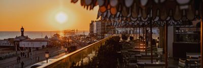 sunset views facing West from Cecconi's Italian restaurant on Brighton's seafront. Things to do in Brighton