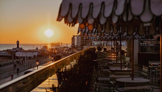 sunset views facing West from Cecconi's Italian restaurant on Brighton's seafront. Things to do in Brighton