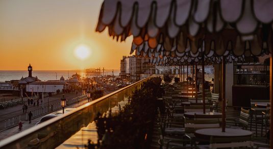 sunset views facing West from Cecconi's Italian restaurant on Brighton's seafront. Things to do in Brighton