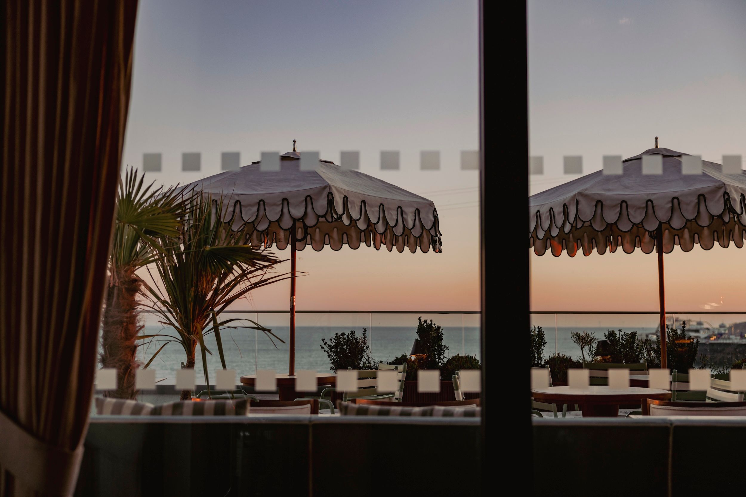 alfresco dining - Cecconi's on Brighton seafront. Sun umbrellas as part of the seaviews. 