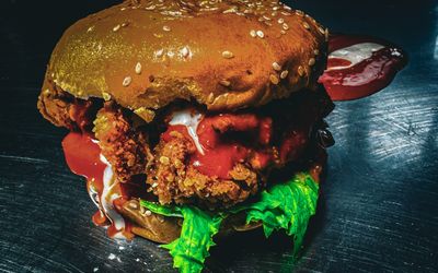 Chicken burger in Hove - The Greenhouse. Dark background. Vibrant colours