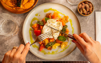 over head shot of person cutting through burrata