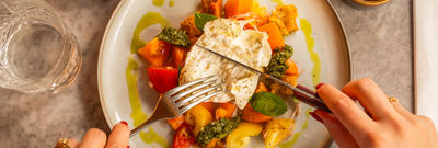 over head shot of person cutting through burrata