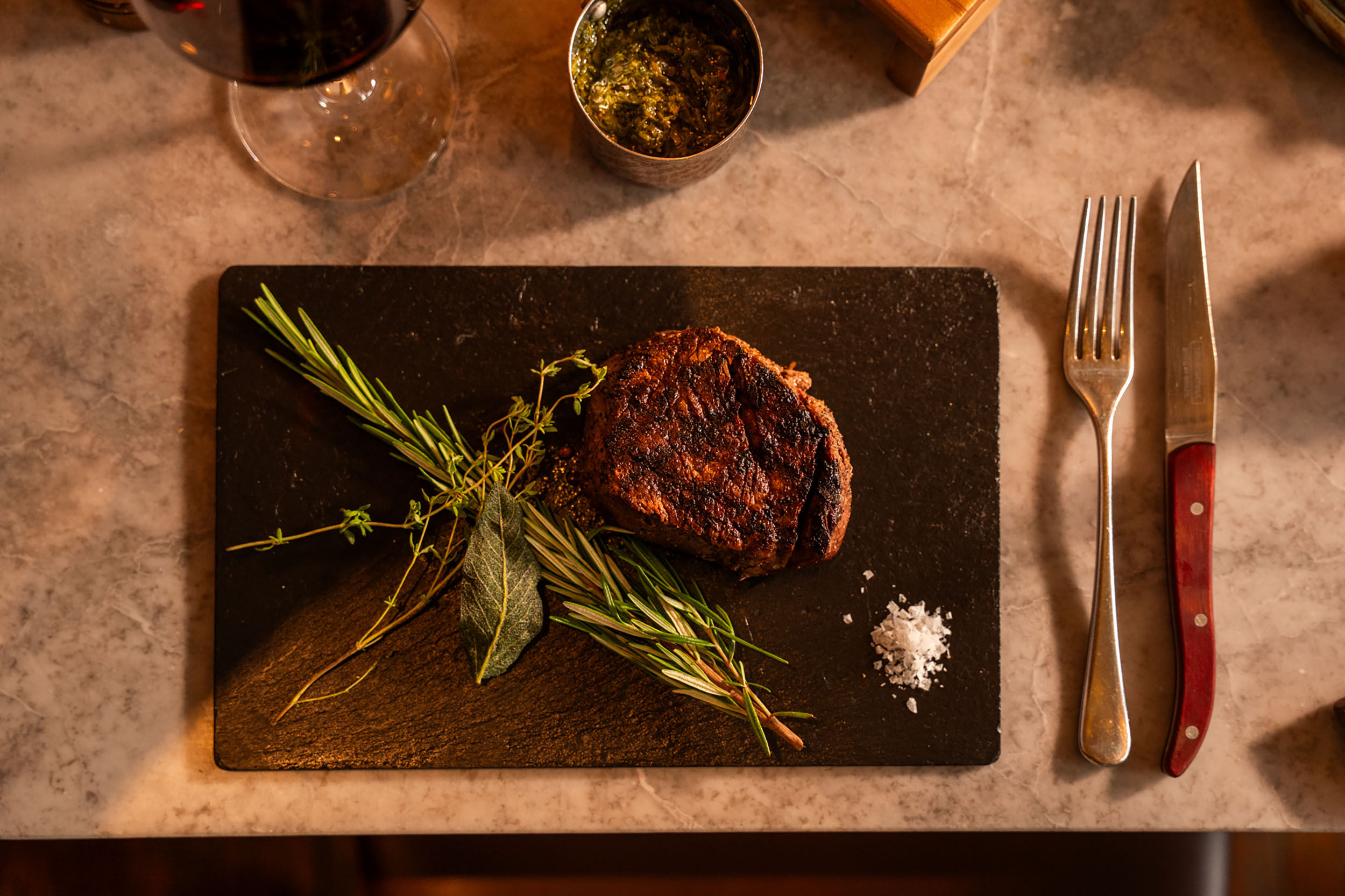 over head shot of the steak served with rosemary
