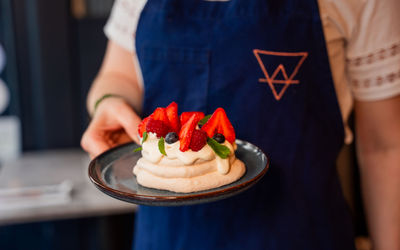 waiter holding dessert on plate at Kindling Brighton