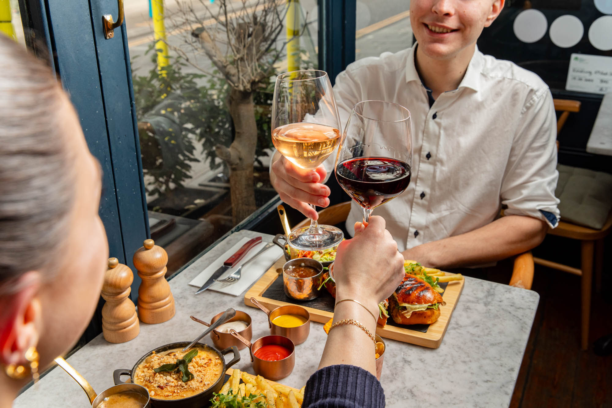 two people enjoying lunch platters and drinks at Kindling