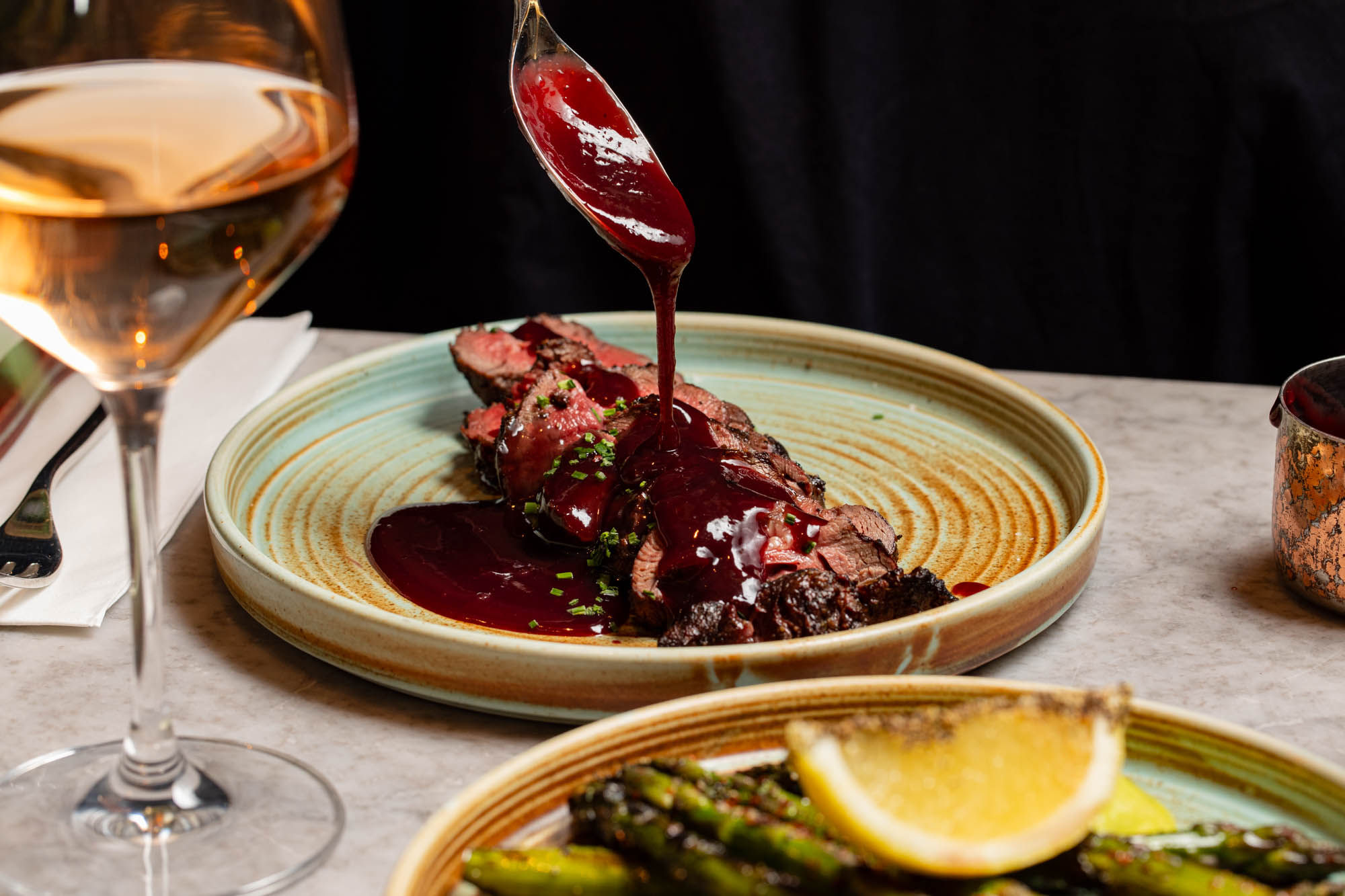 gravy being poured on steak